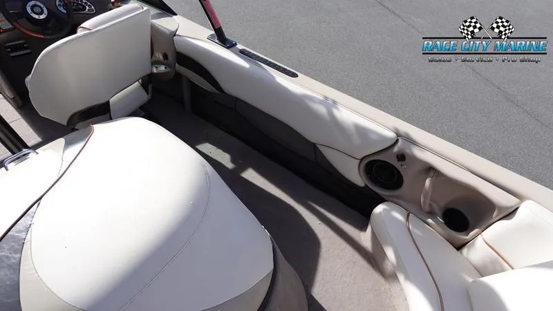 Slide: The Image of 2003 Nautique Air Nautique 216 boat interior with beige seating and dashboard. - 16