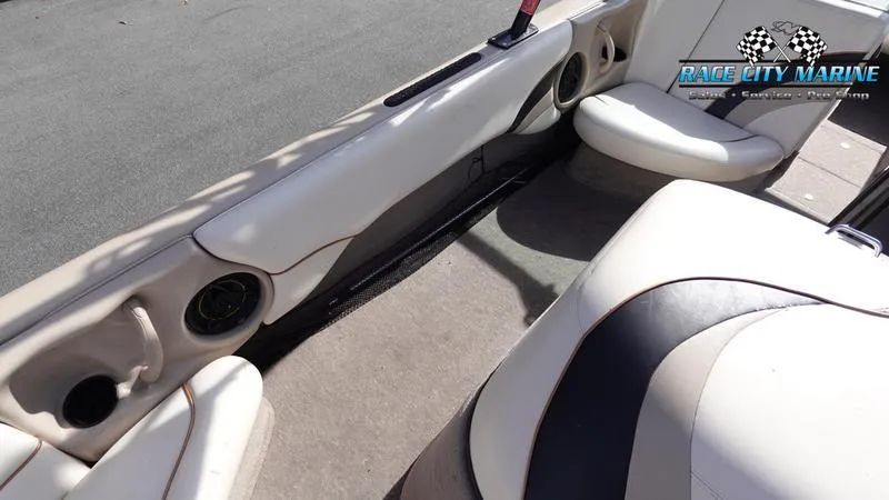 Slide: The Image of 2003 Nautique Air Nautique 216 boat interior with beige seating and cup holders. - 17
