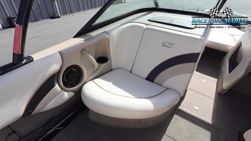 Slide: The Image of 2003 Nautique Air Nautique 216 boat interior with white and beige seating. - 21