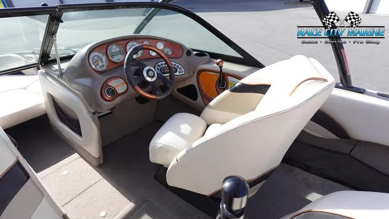 Slide: The Image of 2003 Nautique Air Nautique 216 boat interior with steering wheel and dashboard. - 22