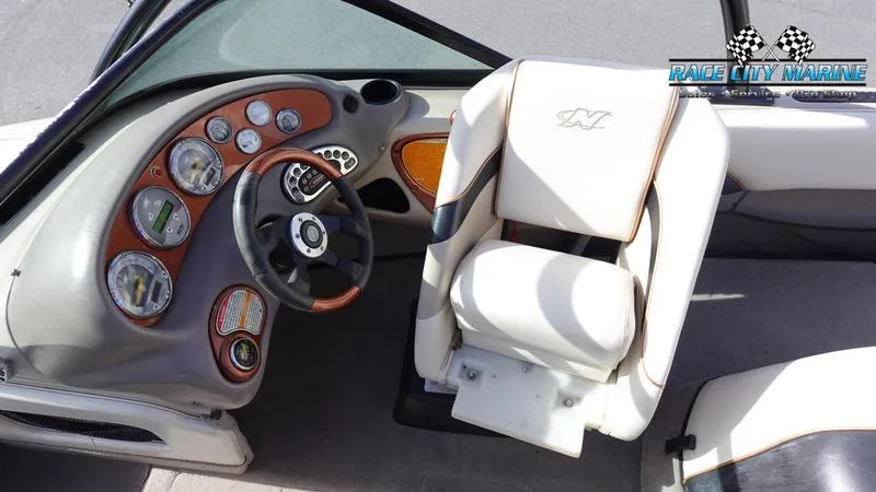 Slide: The Image of 2003 Nautique Air Nautique 216 boat interior with steering wheel and dashboard controls. - 23