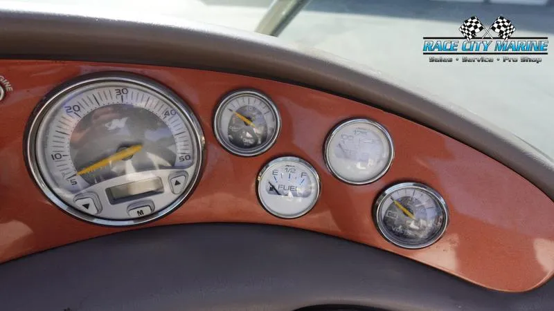 Slide: The Image of 2003 Nautique Air Nautique 216 dashboard with gauges, Race City Marine logo. - 26
