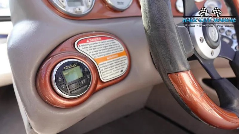 Slide: The Image of 2003 Nautique Air Nautique 216 dashboard with Clarion stereo and warning label. - 28