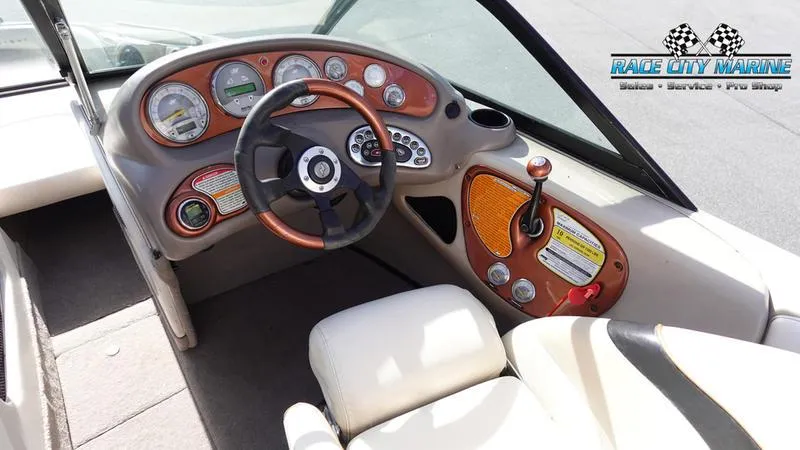 Slide: The Image of 2003 Nautique Air Nautique 216 boat dashboard with steering wheel and controls. - 29