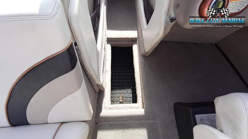 Slide: The Image of 2003 Nautique Air Nautique 216 interior with white and black seating and carpeted flooring. - 30