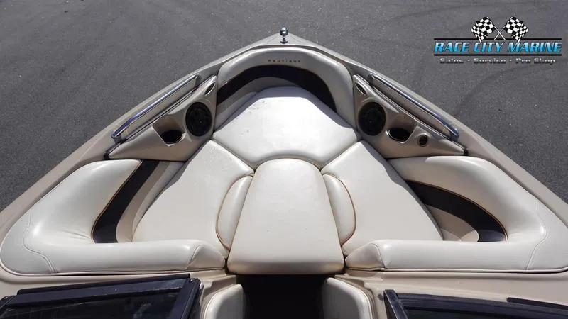 Slide: The Image of 2003 Nautique Air Nautique 216 boat interior with beige seating and Race City Marine logo. - 32