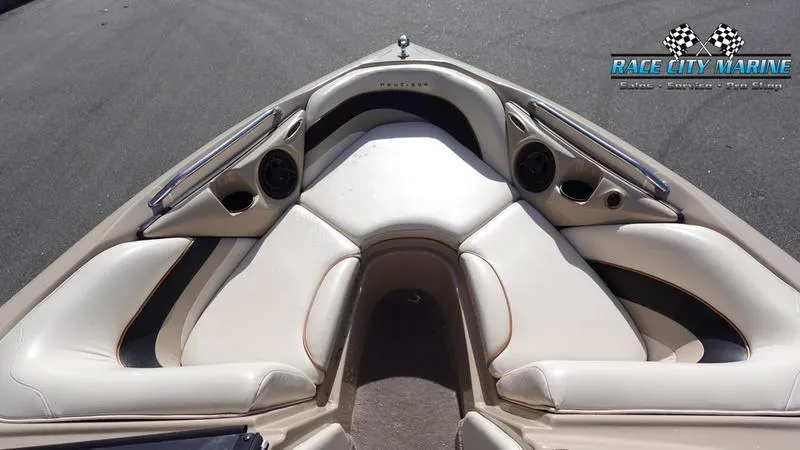 Slide: The Image of 2003 Nautique Air Nautique 216 boat interior with beige seating and Race City Marine logo. - 33