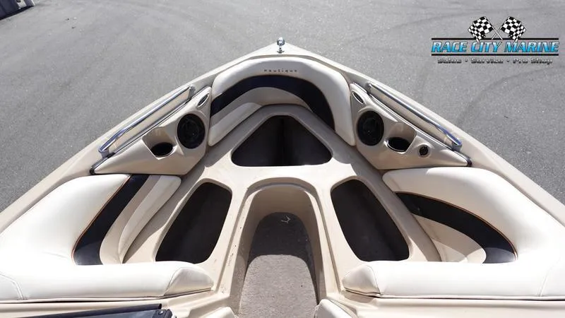 Slide: The Image of 2003 Nautique Air Nautique 216 boat interior with cushioned seating and speakers. - 34