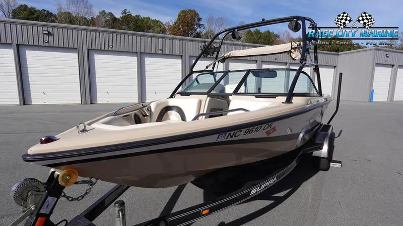 Slide: The Image of 2003 Nautique Air Nautique 216 boat on trailer, parked outside storage units. - 6