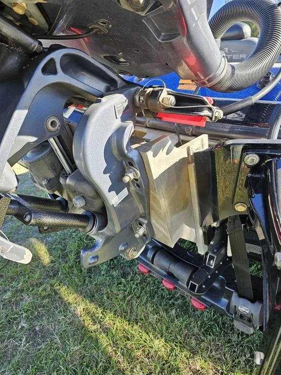 Slide: The Image of Close-up of a 2013 Skeeter 21i boat engine component on grass. - 10