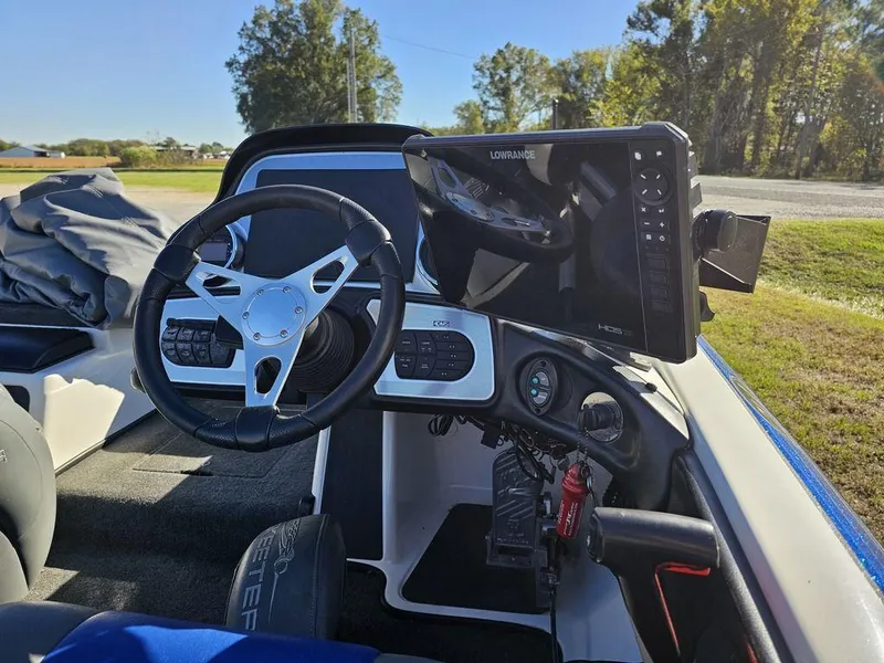 Slide: The Image of 2013 Skeeter 21i boat dashboard with steering wheel and navigation system. - 11