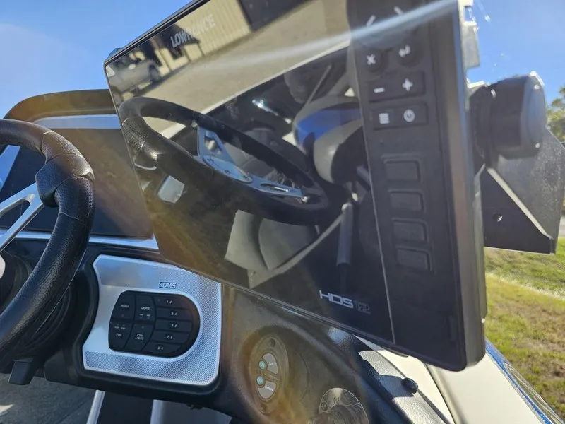 Slide: The Image of 2013 Skeeter 21i boat dashboard with steering wheel and HDS display. - 12