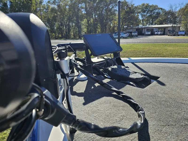 Slide: The Image of 2013 Skeeter 21i boat with mounted electronic display, parked outdoors. - 3