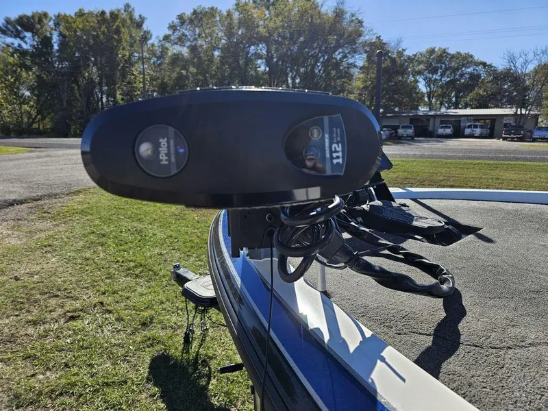 Slide: The Image of 2013 Skeeter 21i boat with trolling motor, parked on grass. - 4