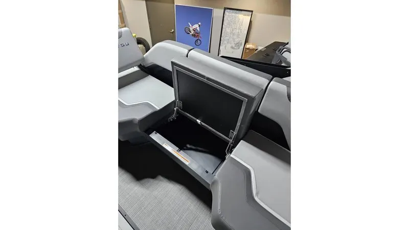 Slide: The Image of 2025 Manitou 20 CRUISE MAX interior with storage compartment, featuring 150hp Rotax Stealth Motor. - 14