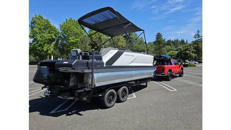 Slide: The Image of 2025 Manitou 20 CRUISE MAX pontoon boat with 150hp Rotax Stealth Motor on trailer. - 3