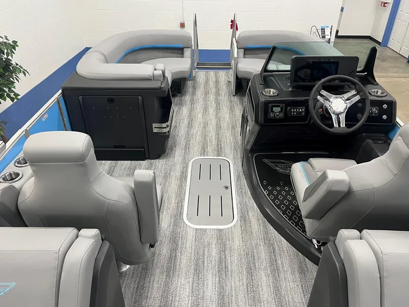 Slide: The Image of 2025 Bennington 22M FASTBACK pontoon boat interior with modern seating and steering console. - 10