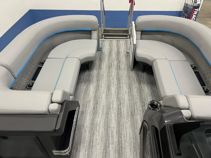Slide: The Image of 2025 Bennington 22M FASTBACK pontoon boat interior with gray seating and modern design. - 11