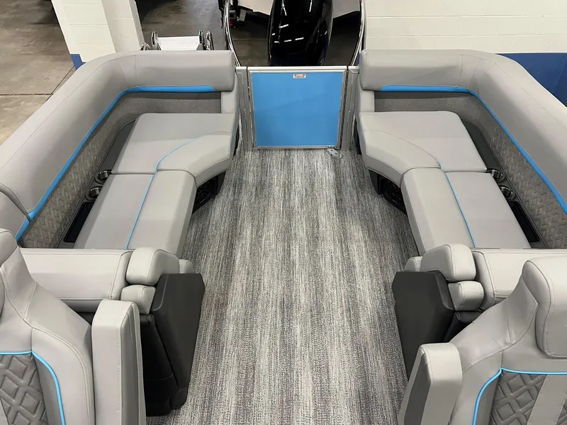 Slide: The Image of 2025 Bennington 22M FASTBACK interior with gray and blue seating, modern design. - 7