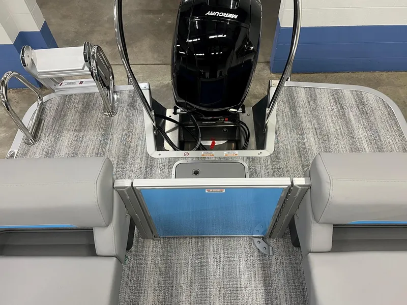 Slide: The Image of 2025 Bennington 22M FASTBACK boat interior with Mercury engine and gray seating. - 8