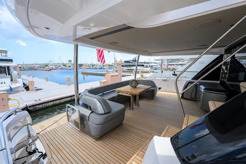 Slide: The Image of Luxurious 2025 Princess Y85 Motor Yacht docked, featuring elegant outdoor seating area. - 12