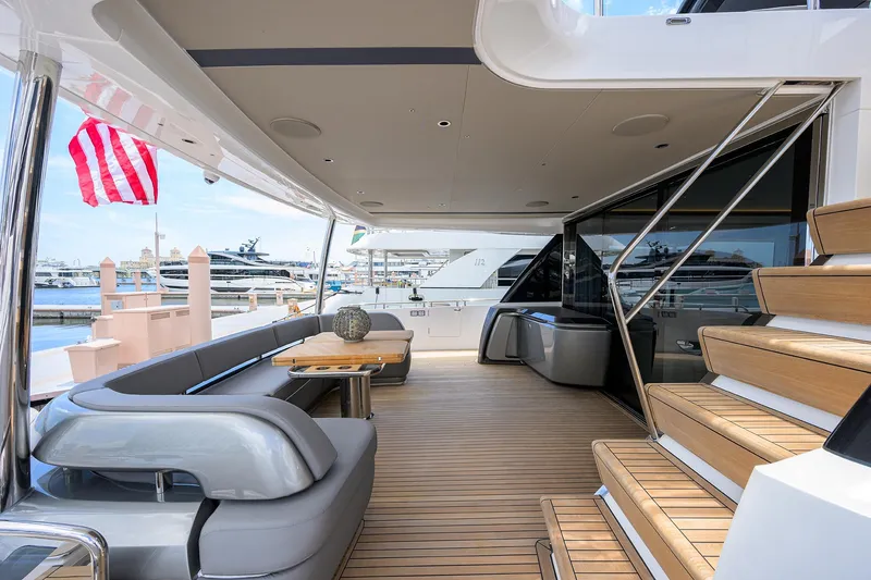 Slide: The Image of Luxurious 2025 Princess Y85 Motor Yacht deck with elegant seating and wooden flooring. - 13