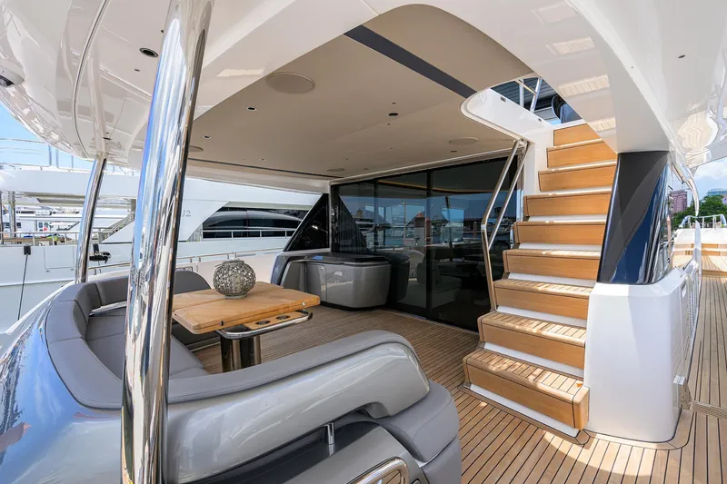 Slide: The Image of Luxurious 2025 Princess Y85 Motor Yacht deck with elegant seating and staircase. - 14
