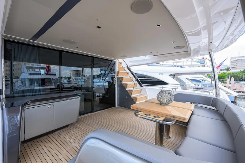 Slide: The Image of Luxurious 2025 Princess Y85 Motor Yacht deck with modern seating and elegant design. - 16