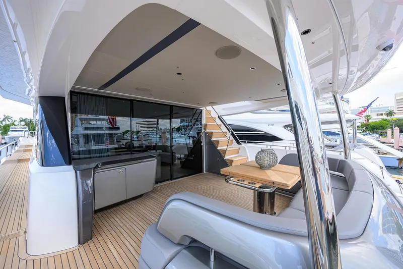 Slide: The Image of Luxurious 2025 Princess Y85 Motor Yacht deck with modern seating and sleek design. - 17