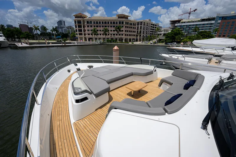 Slide: The Image of Luxurious 2025 Princess Y85 Motor Yacht with spacious deck seating in a marina. - 21
