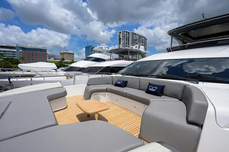 Slide: The Image of Luxurious 2025 Princess Y85 Motor Yacht with spacious deck seating under blue skies. - 23