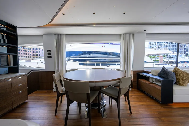 Slide: The Image of Luxurious interior of 2025 Princess Y85 Motor Yacht with elegant dining area and marina view. - 32