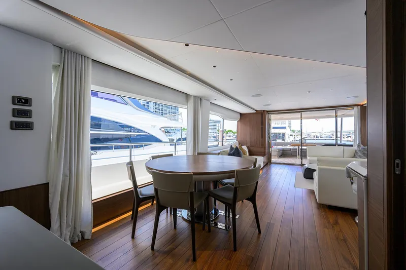 Slide: The Image of Luxurious interior of 2025 Princess Y85 Motor Yacht with elegant dining area and large windows. - 34