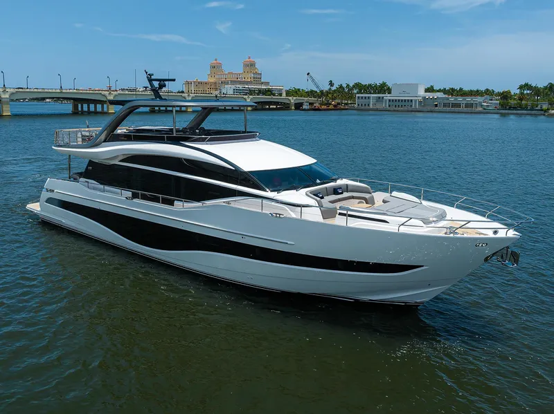 Slide: The Image of 2025 Princess Y85 Motor Yacht cruising on a sunny day near a bridge. - 4