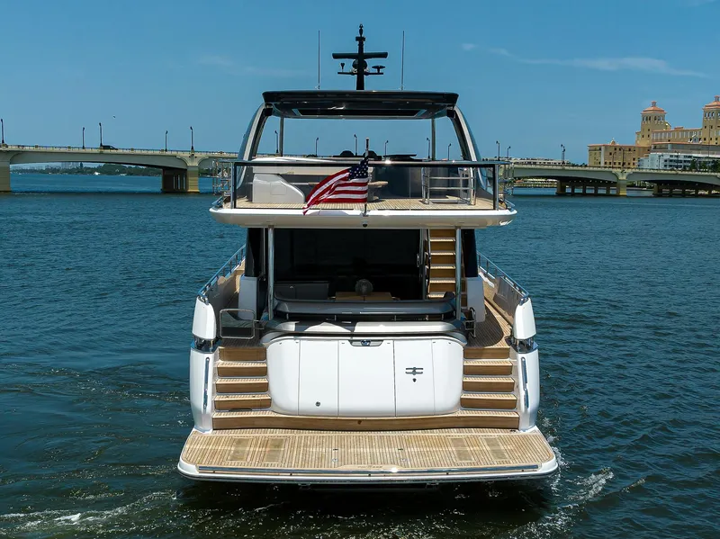 Slide: The Image of 2025 Princess Y85 Motor Yacht on water, rear view with American flag. - 7