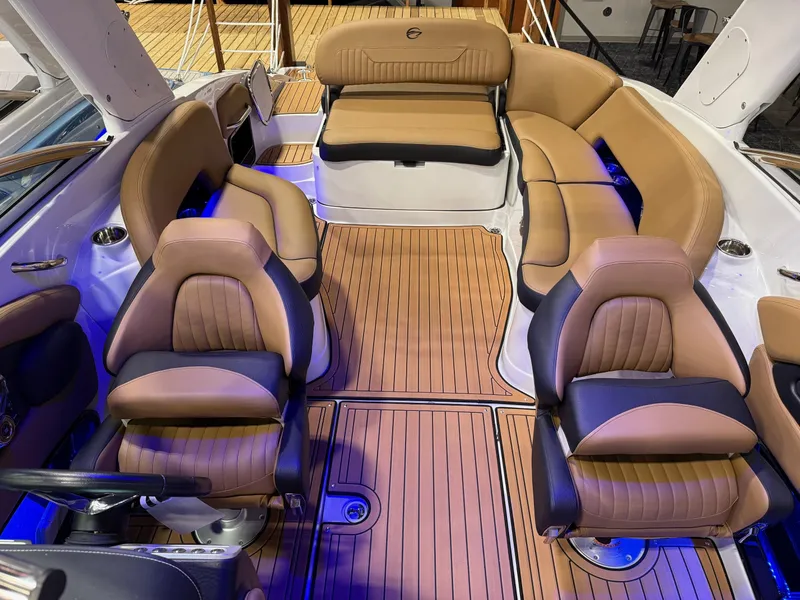 Slide: The Image of 2025 Crownline 280 SS boat interior with tan leather seating and wood flooring. - 3