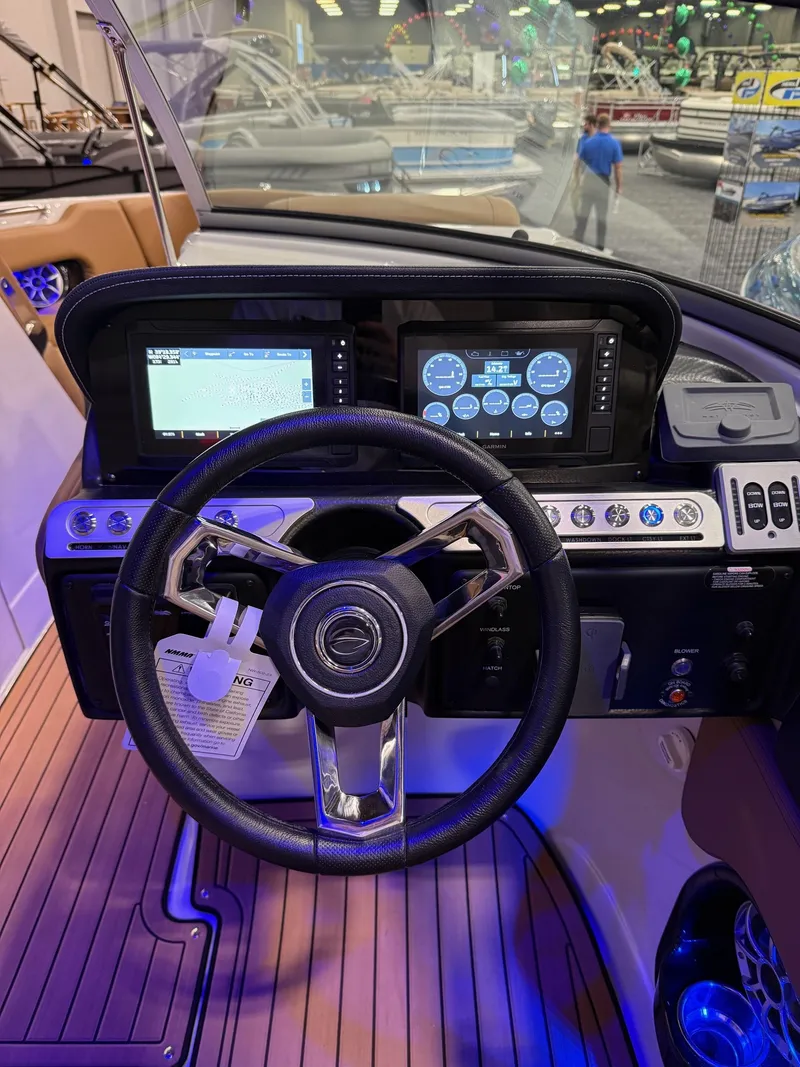 Slide: The Image of 2025 Crownline 280 SS dashboard with modern controls and dual display screens. - 8