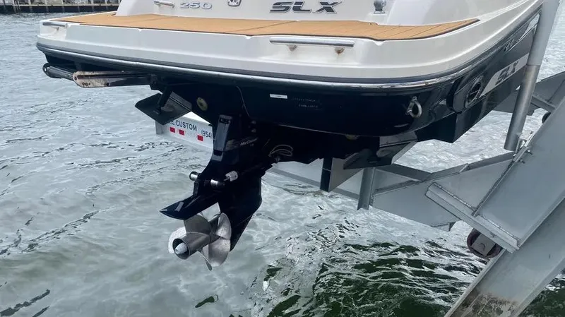 Slide: The Image of 2015 Sea Ray 250 SLX boat on lift, rear view with propeller. - 10