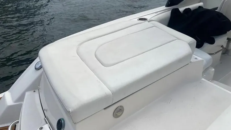 Slide: The Image of 2015 Sea Ray 250 SLX boat seating area by the water. - 11