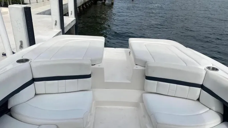 Slide: The Image of 2015 Sea Ray 250 SLX boat with white seating, docked by the water. - 14