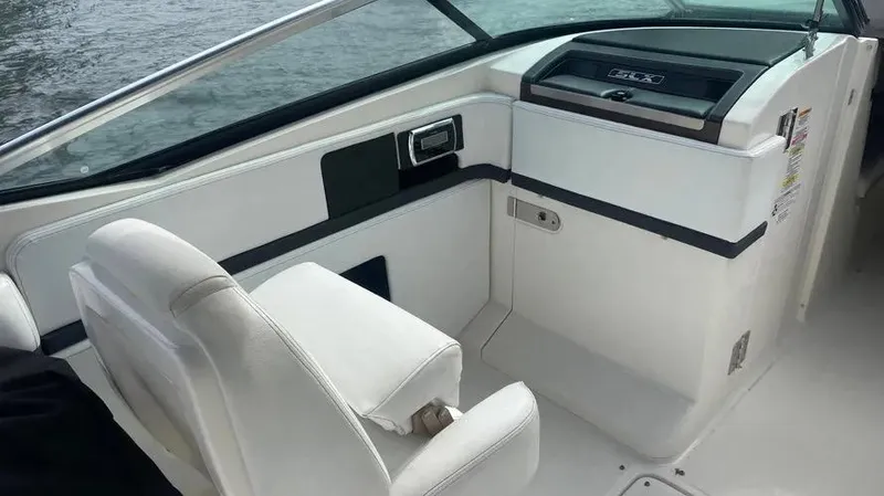 Slide: The Image of Interior of 2015 Sea Ray 250 SLX boat with white seating and dashboard. - 18
