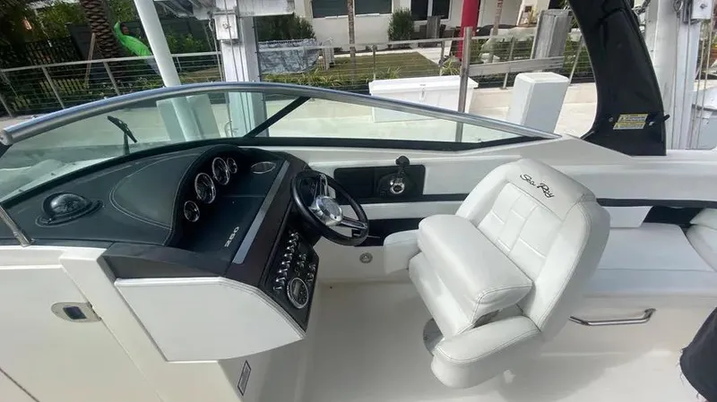 Slide: The Image of 2015 Sea Ray 250 SLX boat interior with steering wheel and captain's chair. - 21
