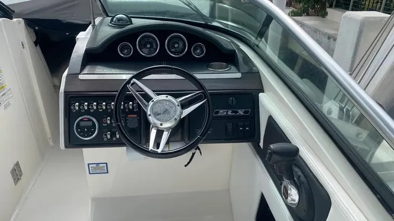 Slide: The Image of 2015 Sea Ray 250 SLX boat dashboard with steering wheel and gauges. - 22