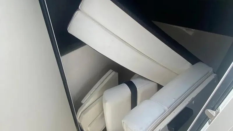 Slide: The Image of Cushions stored in a compartment of a 2015 Sea Ray 250 SLX boat. - 24