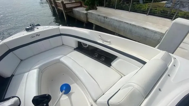 Slide: The Image of 2015 Sea Ray 250 SLX boat interior with white seating and cup holders. - 25