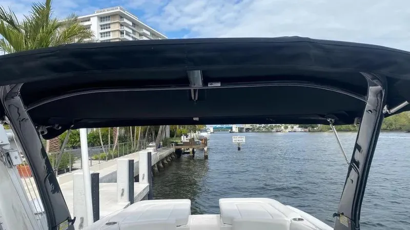 Slide: The Image of 2015 Sea Ray 250 SLX boat docked by waterfront with canopy and scenic view. - 27