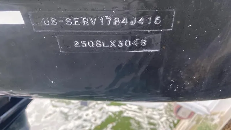 Slide: The Image of 2015 Sea Ray 250 SLX hull identification number on black surface. - 29