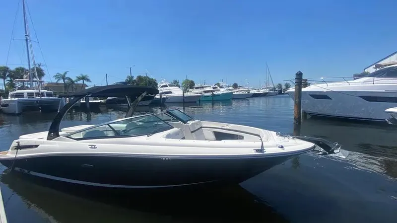 Slide: The Image of 2015 Sea Ray 250 SLX boat docked in a sunny marina. - 8