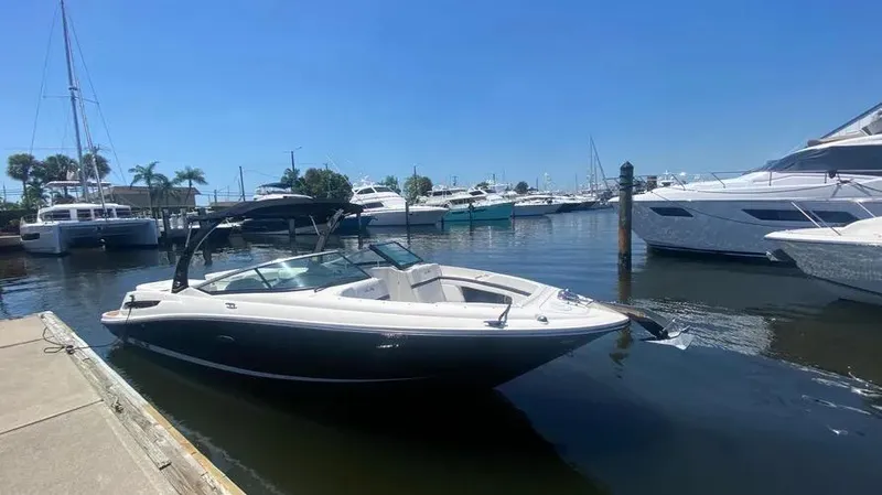 Slide: The Image of 2015 Sea Ray 250 SLX boat docked in a marina under clear blue skies. - 9