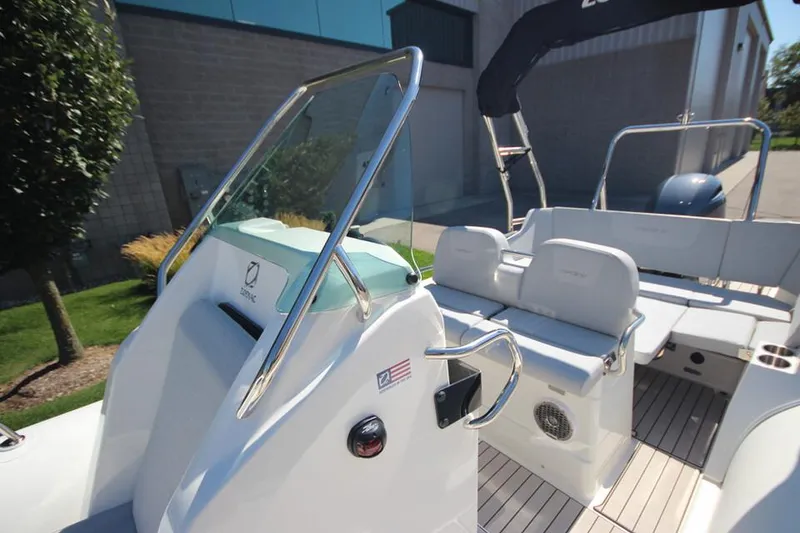 Slide: The Image of 2025 Zodiac Medline 6.8 NEO boat with 200hp engine, docked outdoors. - 16
